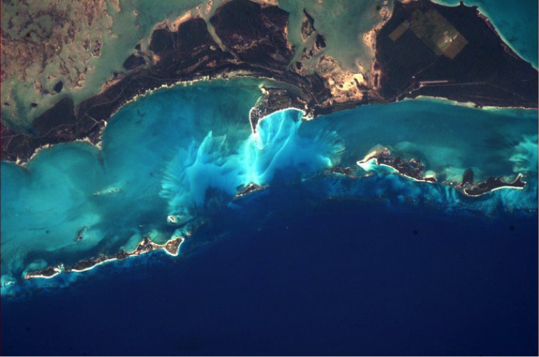 Photo by Chris Hadfield, Astronaut who said in an interview: "The most beautiful [view] to me are the Bahamas, the vast glowing reefs of every shade of blue that exists". http://www.bbc.com/news/technology-21497468